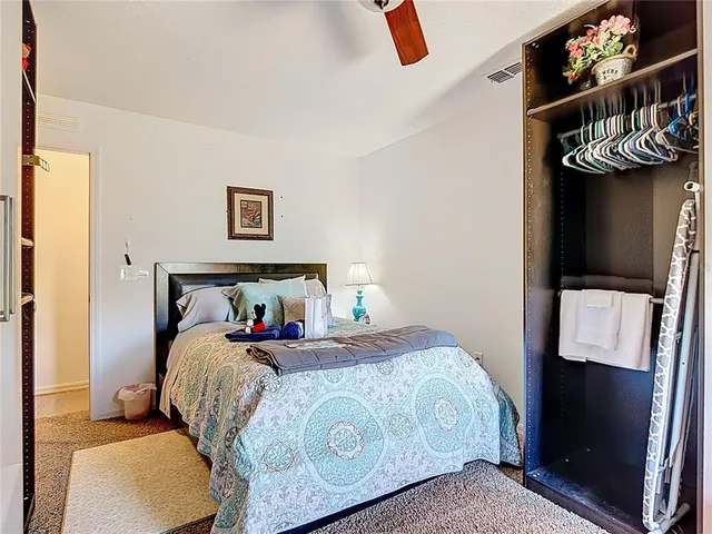 a bedroom with a bed and painting on the wall