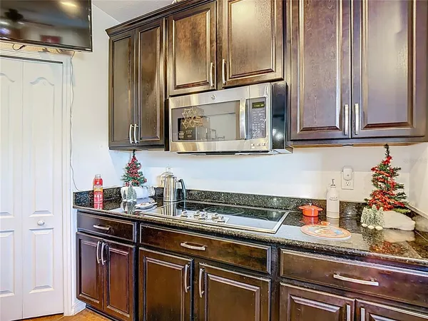 a kitchen with stainless steel appliances granite countertop a refrigerator and cabinets