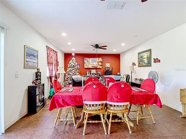 a view of a dining room with furniture and chandelier