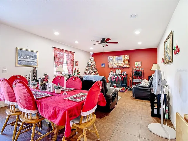 a living room with furniture kitchen view and a large window