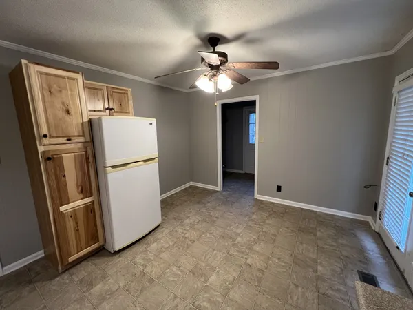 a view of a kitchen with a refrigerator a ceiling fan and a refrigerator