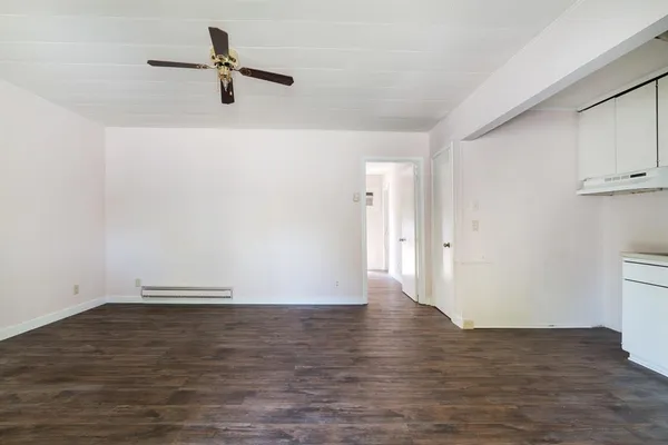 a view of a room with wooden floor