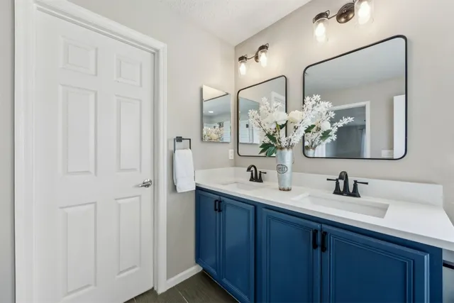 a bathroom with a tub sink and mirror