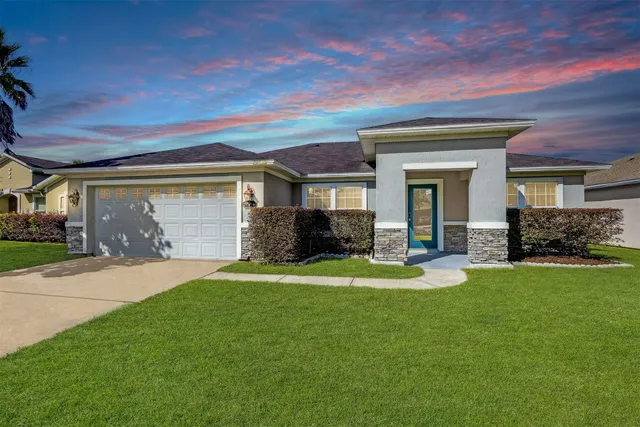 a front view of a house with garden