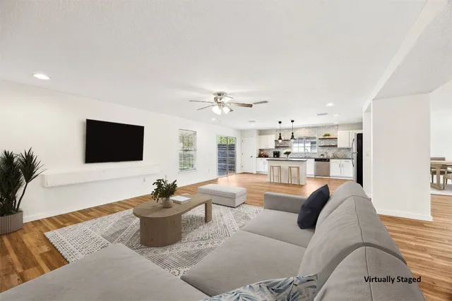 a dining room with furniture and wooden floor