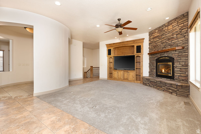 888 East Fiddlers Canyon Road Cedar City, UT 84721 - Photo 10 of 74 Unfurnished living room with light carpet, light tile patterned floors, a ceiling fan, arched walkways, and recessed lighting