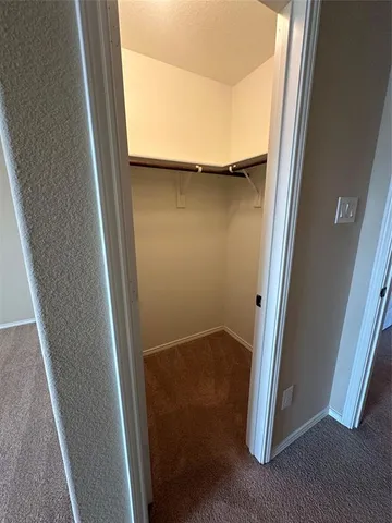 an empty room with a ceiling fan and window