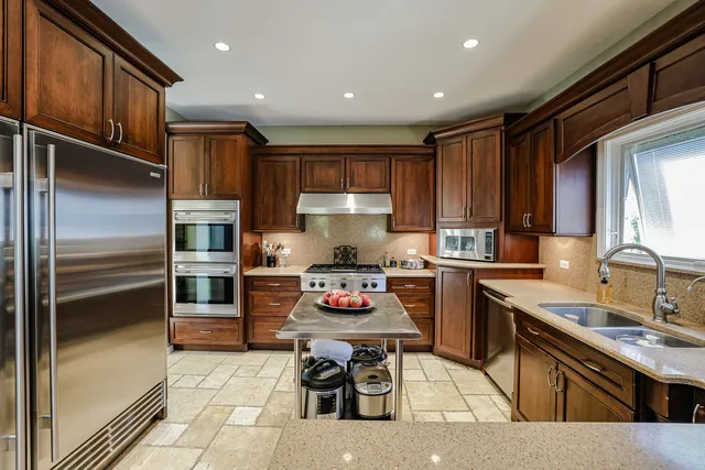 a kitchen with a sink stove and refrigerator