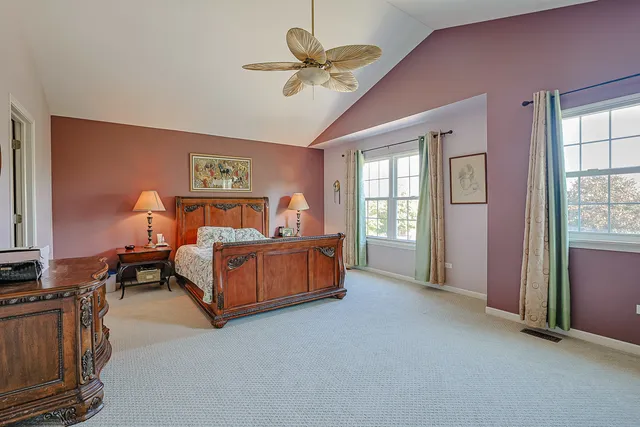 a spacious bedroom with a bed and a window