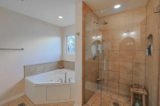 a bathroom with a tub a sink and shower