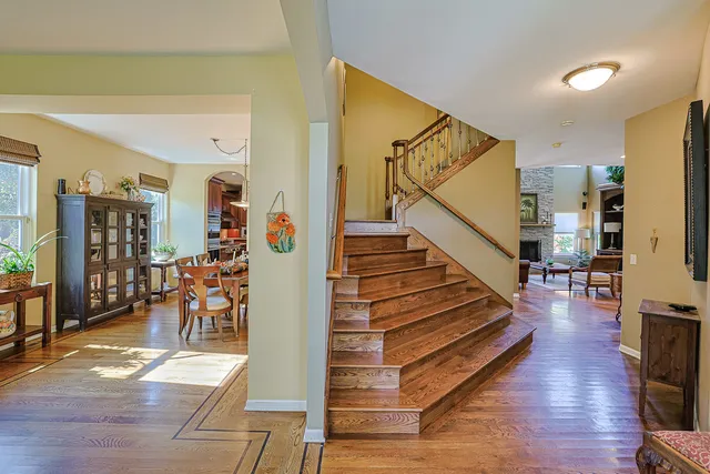 a view of entryway and hall with wooden floor