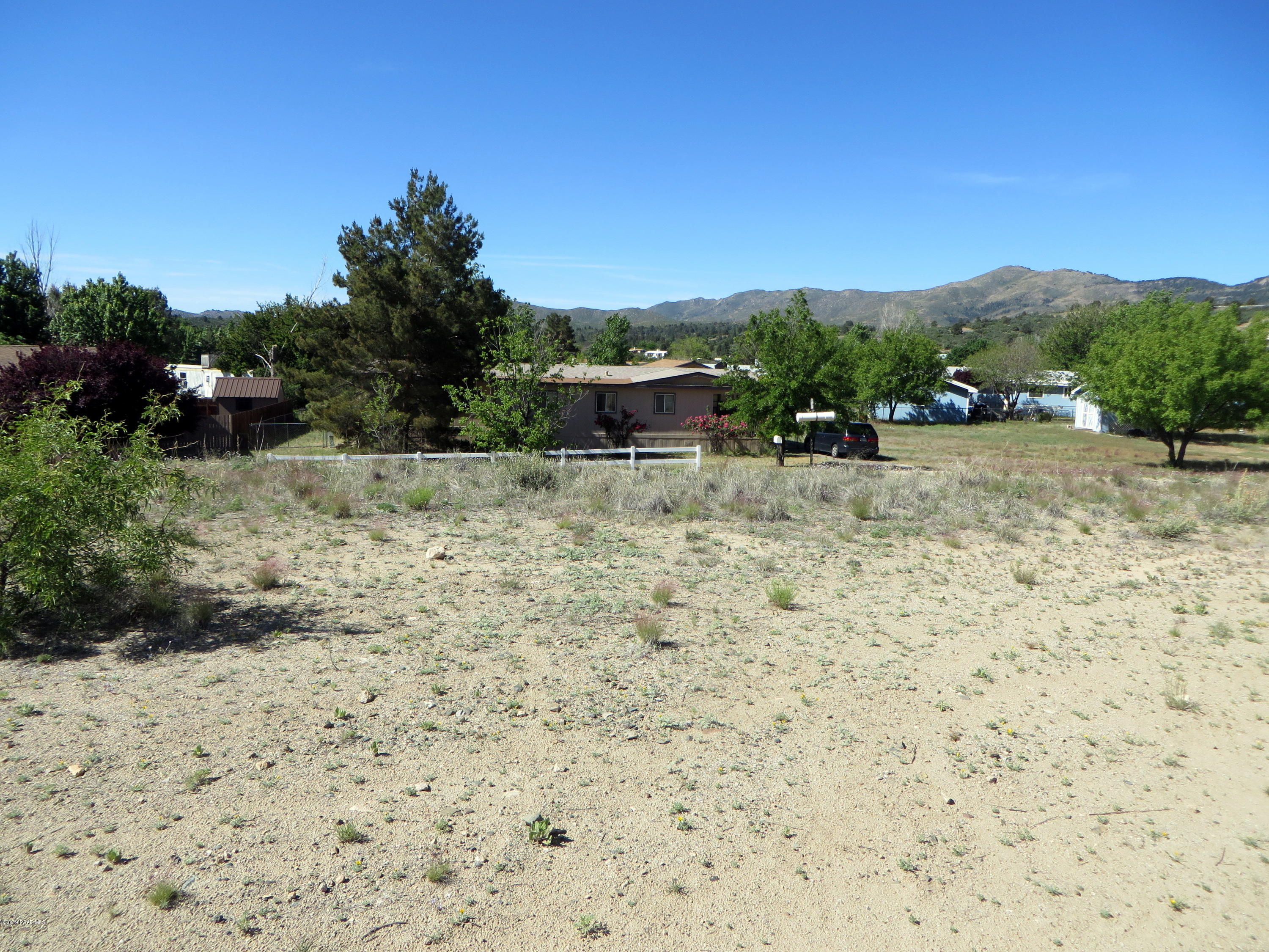 16990 Double Tree Road Peeples Valley, AZ 86332 - Photo 3 of 6 a backyard of a house with lots of green space