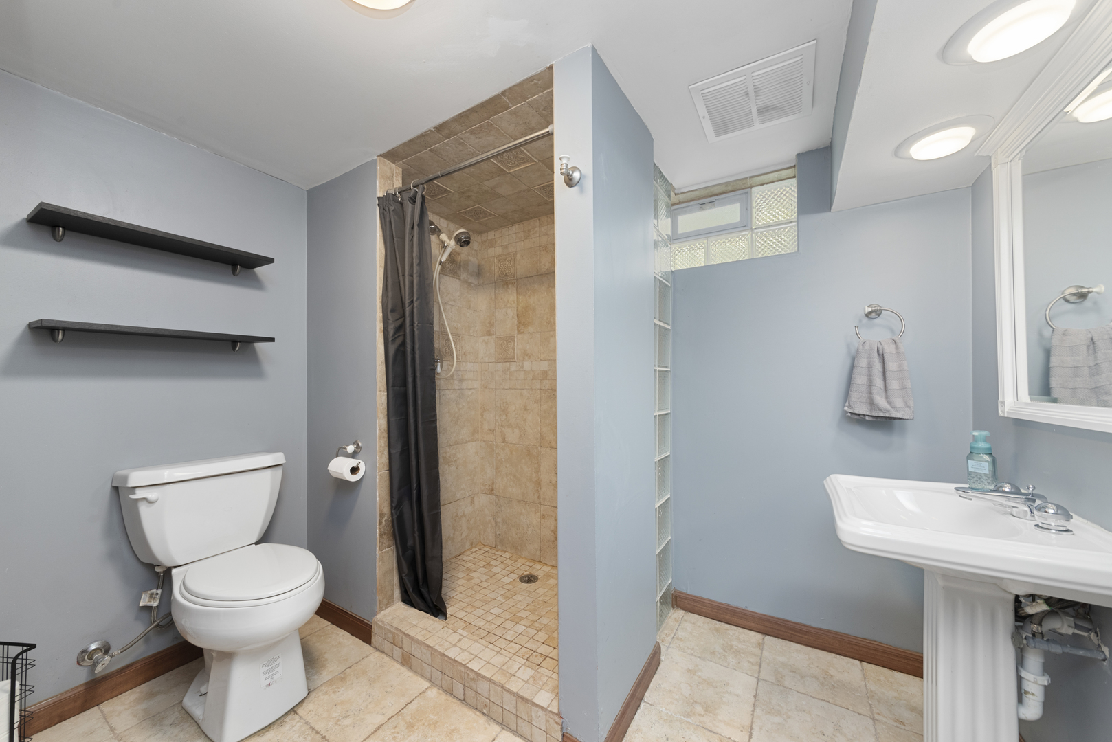 943 Sumner Street Addison, IL 60101 - Photo 15 of 20 a bathroom with a toilet a sink and mirror