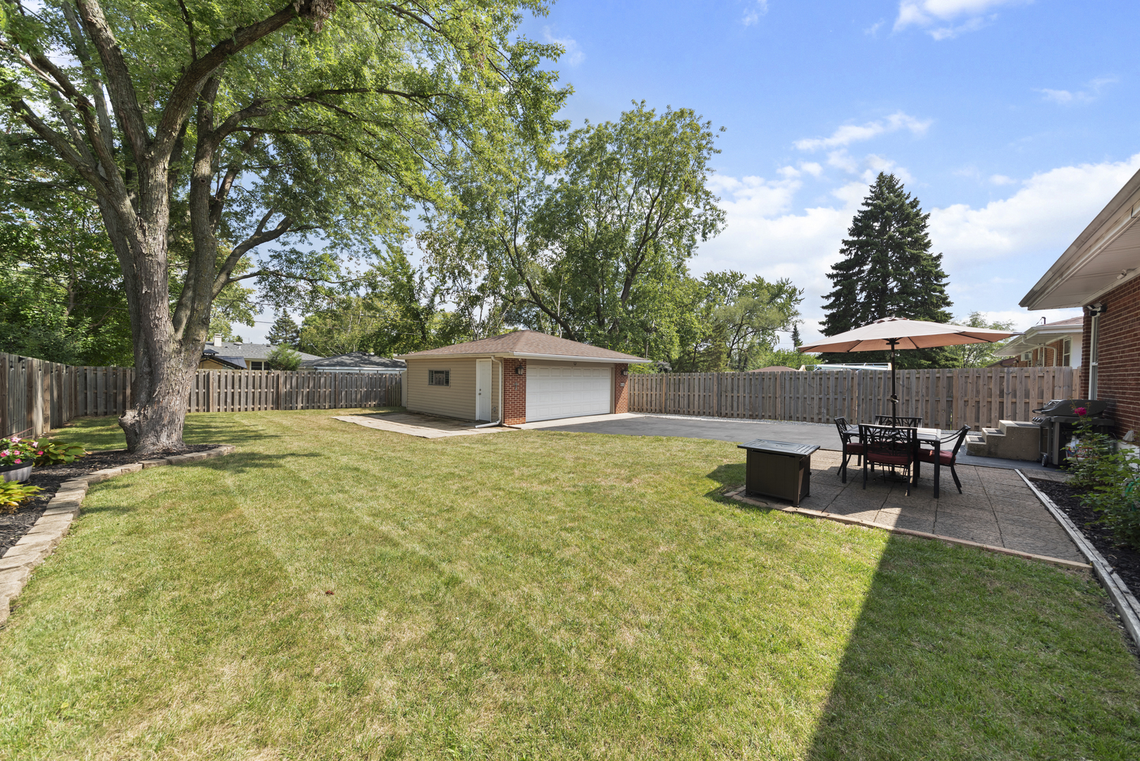 943 Sumner Street Addison, IL 60101 - Photo 18 of 20 a backyard of a house with table and chairs