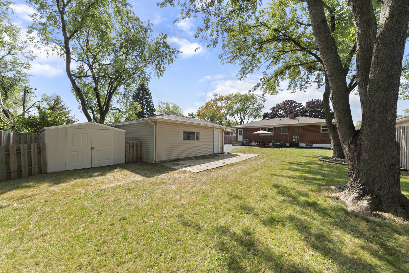 943 Sumner Street Addison, IL 60101 - Photo 20 of 20 a house view with a trees in the background