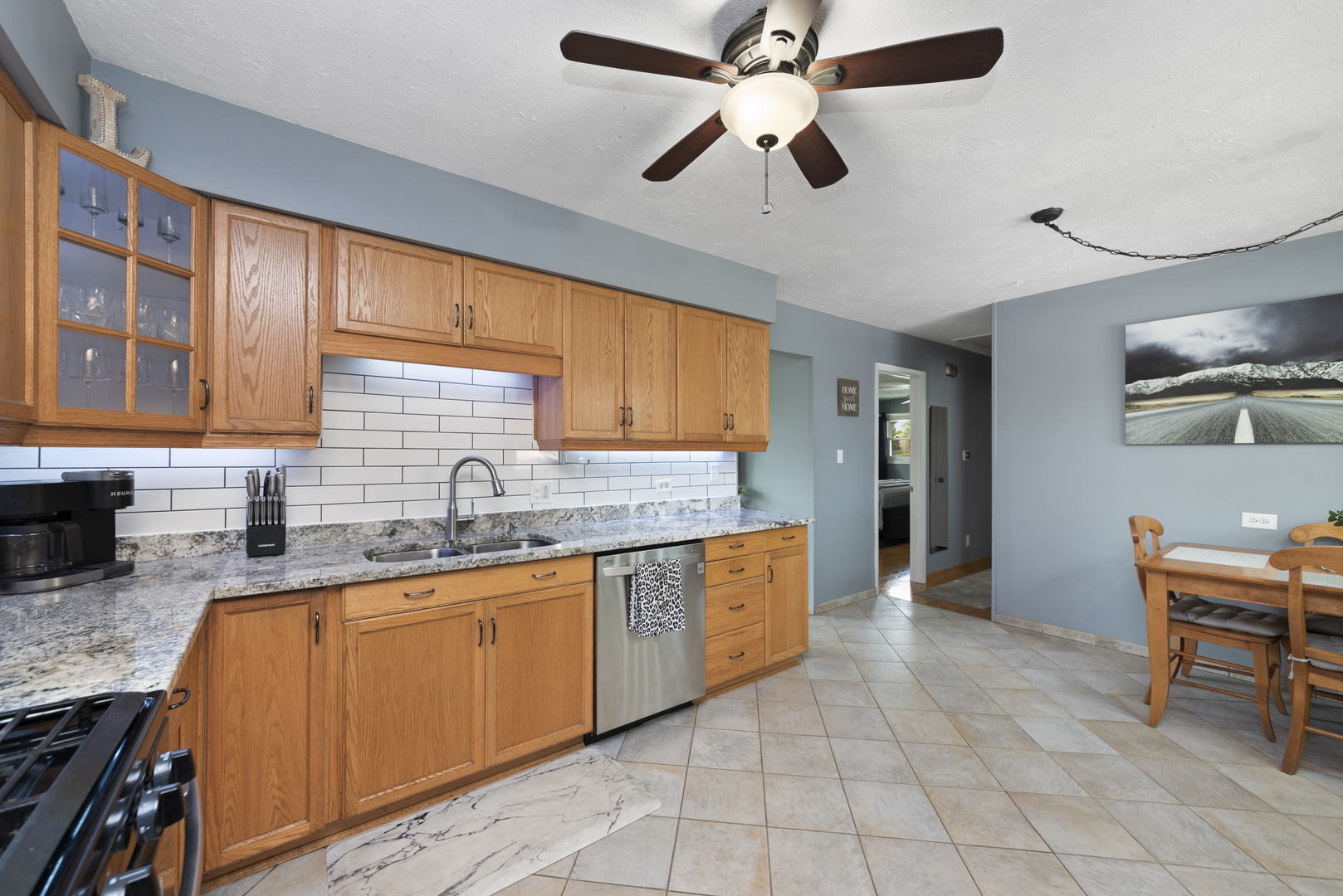 943 Sumner Street Addison, IL 60101 - Photo 4 of 20 a kitchen with stainless steel appliances granite countertop a sink a stove cabinets and dining table