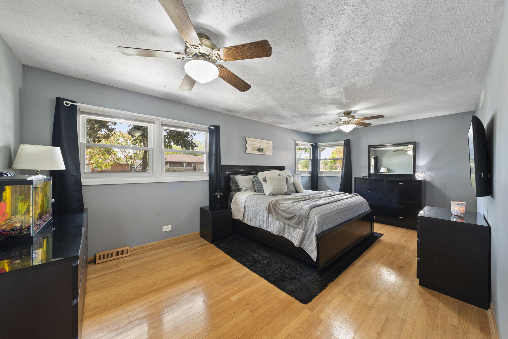 943 Sumner Street Addison, IL 60101 - Photo 8 of 20 a spacious bedroom with a large bed and a chandelier