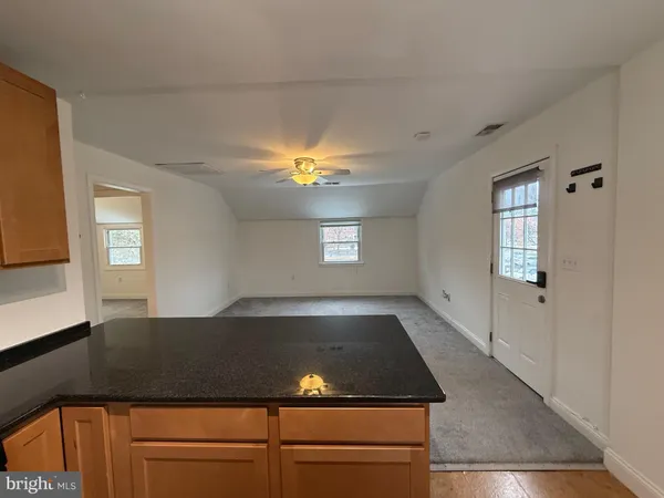 a view of a kitchen with a sink and a window