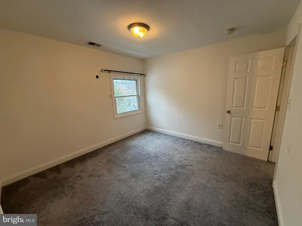 an empty room with closet area