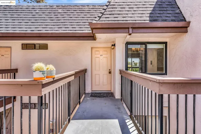 a view of a porch with wooden floor and fence