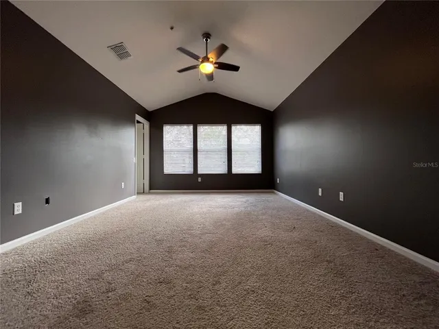 a view of a livingroom with a ceiling fan and window