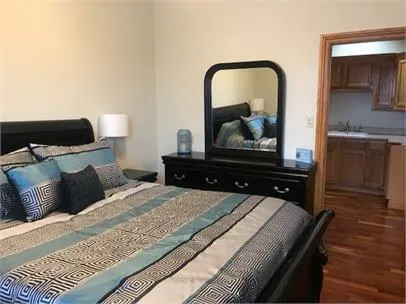 a bedroom with a bed and a dresser
