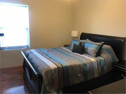 4219 South Union Avenue, Unit 2 Chicago, IL 60609 - Photo 14 of 25 a bedroom with a bed and wooden floor