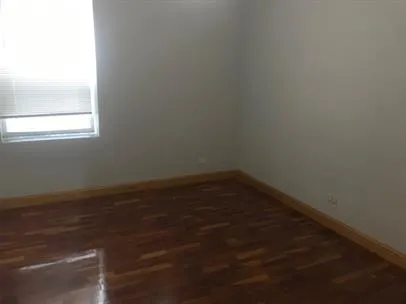 a view of a small space with wooden floor and a window