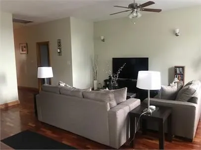 a living room with furniture and a lamp