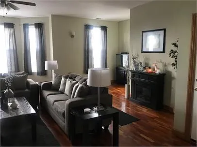 a living room with furniture and wooden floor