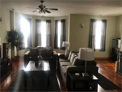 a living room with furniture and a chandelier