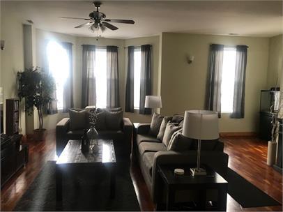 4219 South Union Avenue, Unit 2 Chicago, IL 60609 - Photo 4 of 25 a living room with furniture and a chandelier