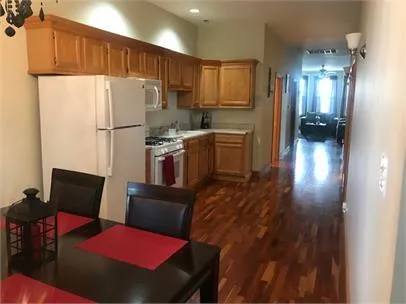 a kitchen with a refrigerator a stove top oven a sink and cabinets