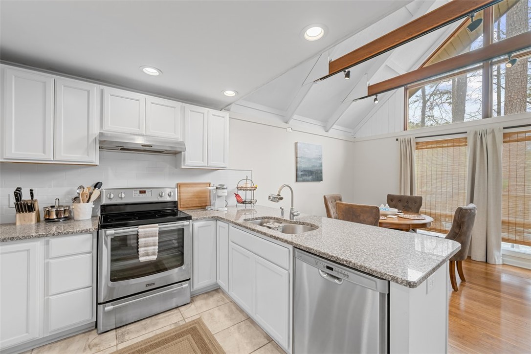 560 South Flagship Drive, Unit 6 Salem, SC 29676 - Photo 2 of 14 This kitchen features sleek countertops, modern appliances, and a vaulted ceiling with abundant natural light.
