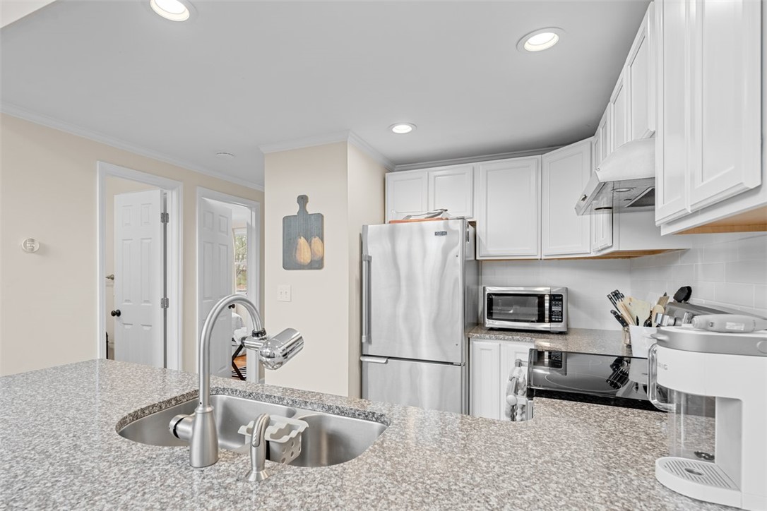560 South Flagship Drive, Unit 6 Salem, SC 29676 - Photo 3 of 14 This bright kitchen features white cabinetry and stainless steel appliances, creating a contemporary culinary space.