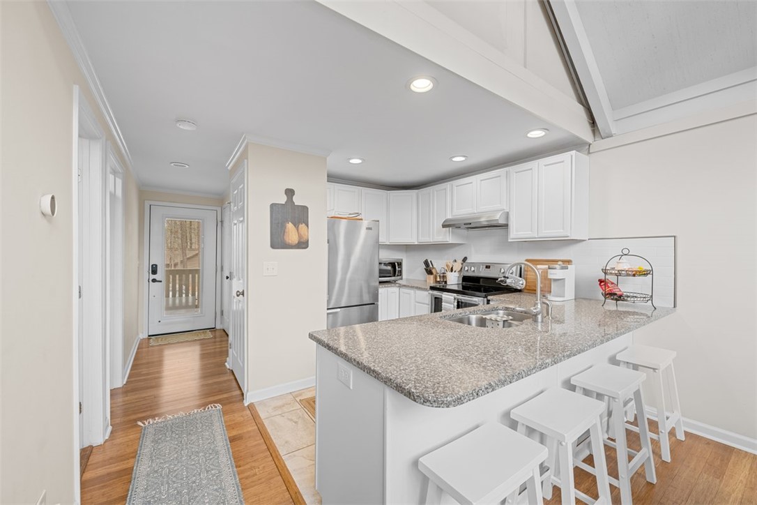 560 South Flagship Drive, Unit 6 Salem, SC 29676 - Photo 4 of 14 This bright kitchen features ample counter space, modern appliances, and a charming breakfast bar.