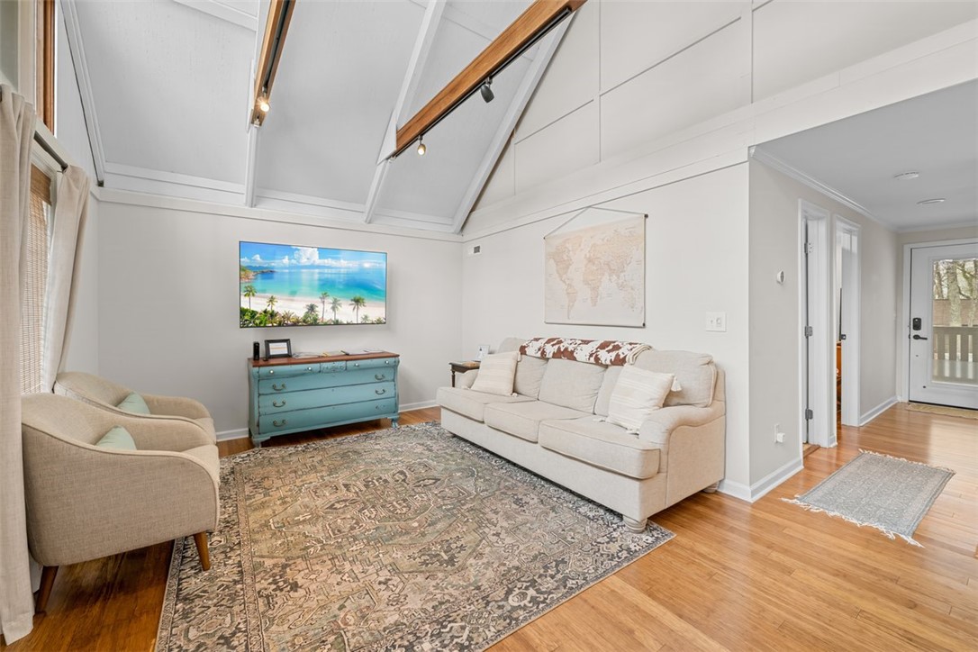 560 South Flagship Drive, Unit 6 Salem, SC 29676 - Photo 6 of 14 This living room features vaulted ceilings, warm wood flooring, and ample natural light.