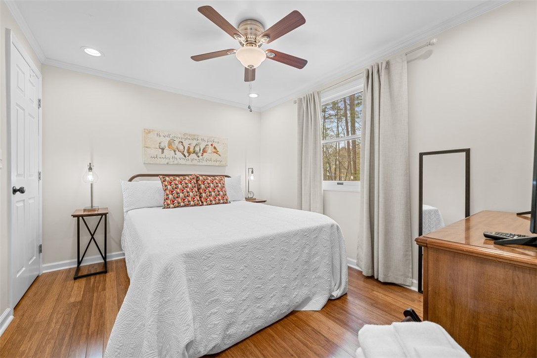 560 South Flagship Drive, Unit 6 Salem, SC 29676 - Photo 9 of 14 This cozy bedroom offers rich hardwood flooring and abundant natural light through a large window.