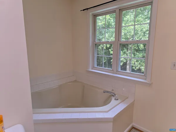 a bath tub sitting next to a window