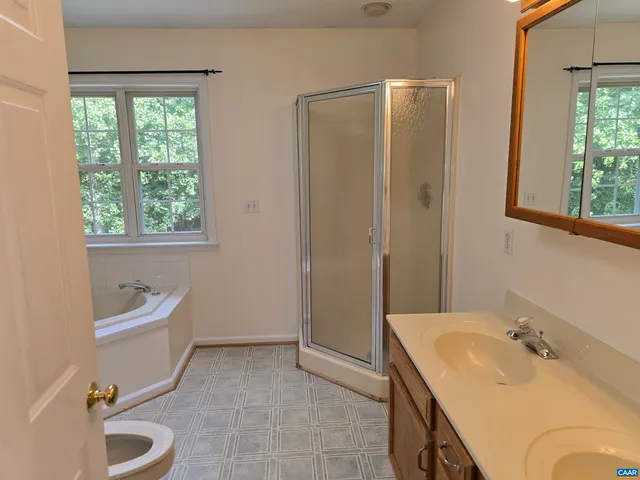 a bathroom with a tub sink and mirror