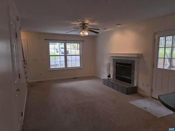 a view of empty room with window and fireplace