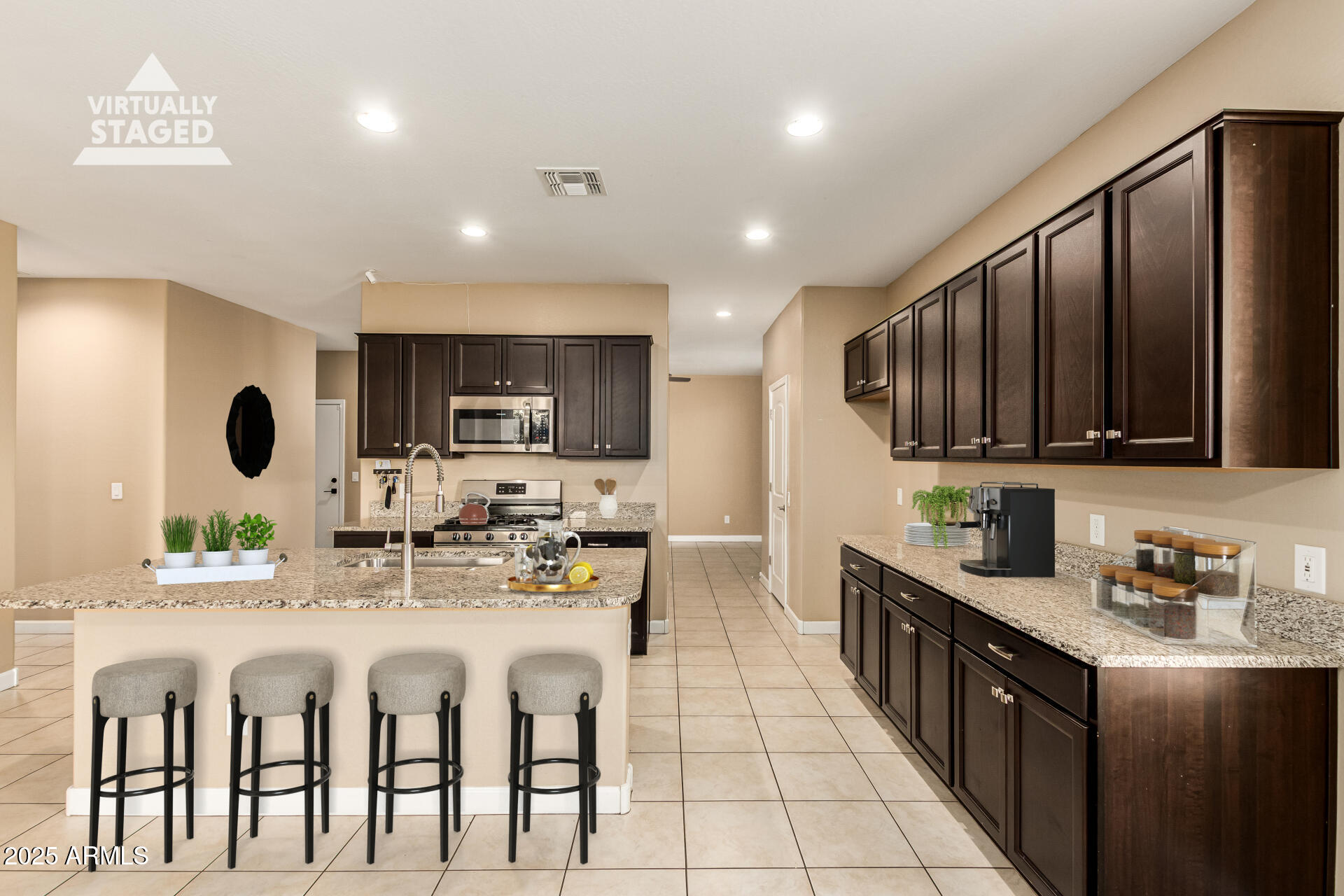 4170 West South Butte Road San Tan Valley, AZ 85144 - Photo 12 of 47 a kitchen with stainless steel appliances kitchen island granite countertop a sink and cabinets