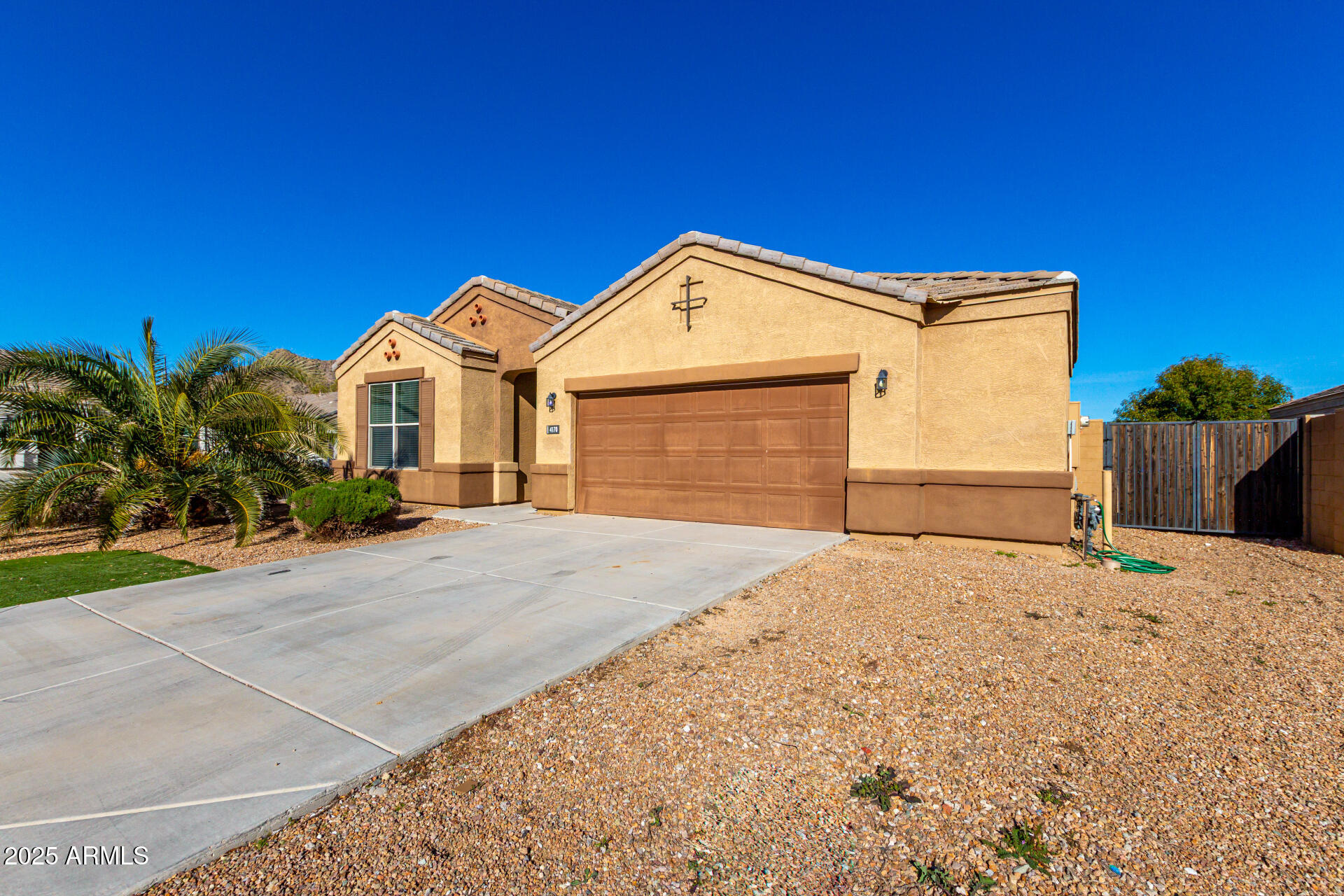 4170 West South Butte Road San Tan Valley, AZ 85144 - Photo 2 of 47 a front view of a house with a yard and garage