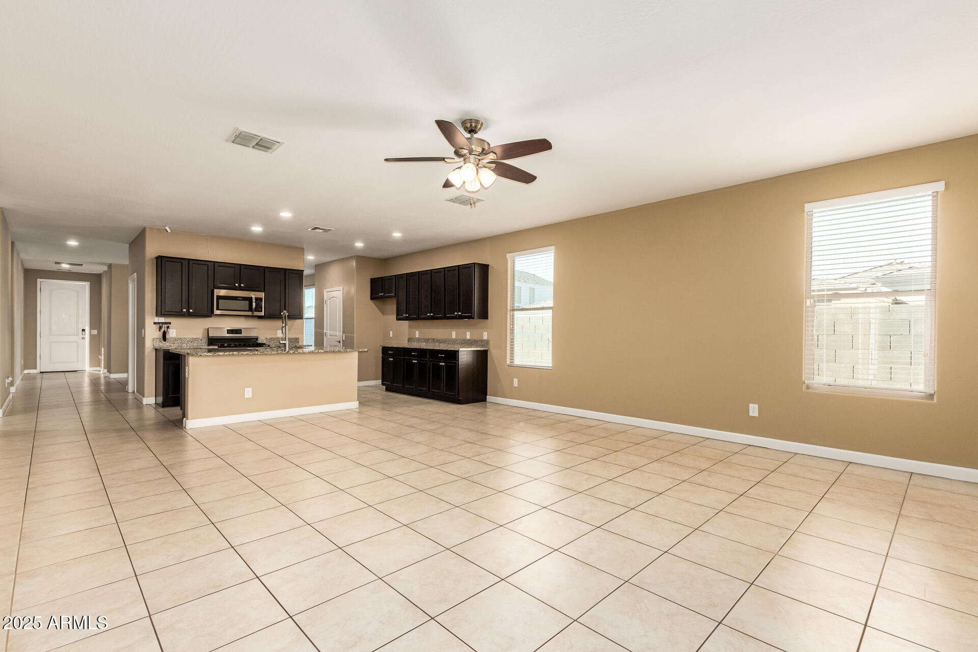 4170 West South Butte Road San Tan Valley, AZ 85144 - Photo 8 of 47 a view of kitchen with stainless steel appliances kitchen island granite countertop a refrigerator and a stove top oven