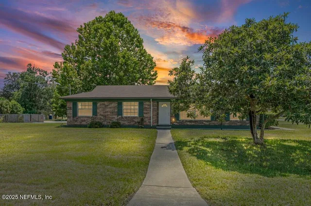 a view of a house with a yard