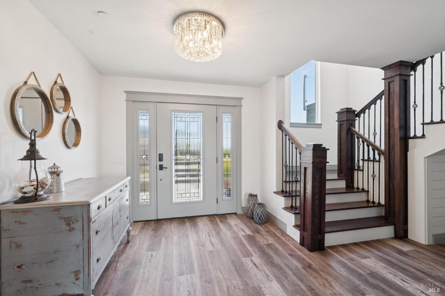 88 Cypress Loop Bodega Bay, CA 94923 - Photo 22 of 88 Left of the entryway is the sophisticated staircase featuring oak wood railing and a cozy built in nook. In addition to the stairs, there is also a convenient elevator to access the main living space & upstairs bedrooms.