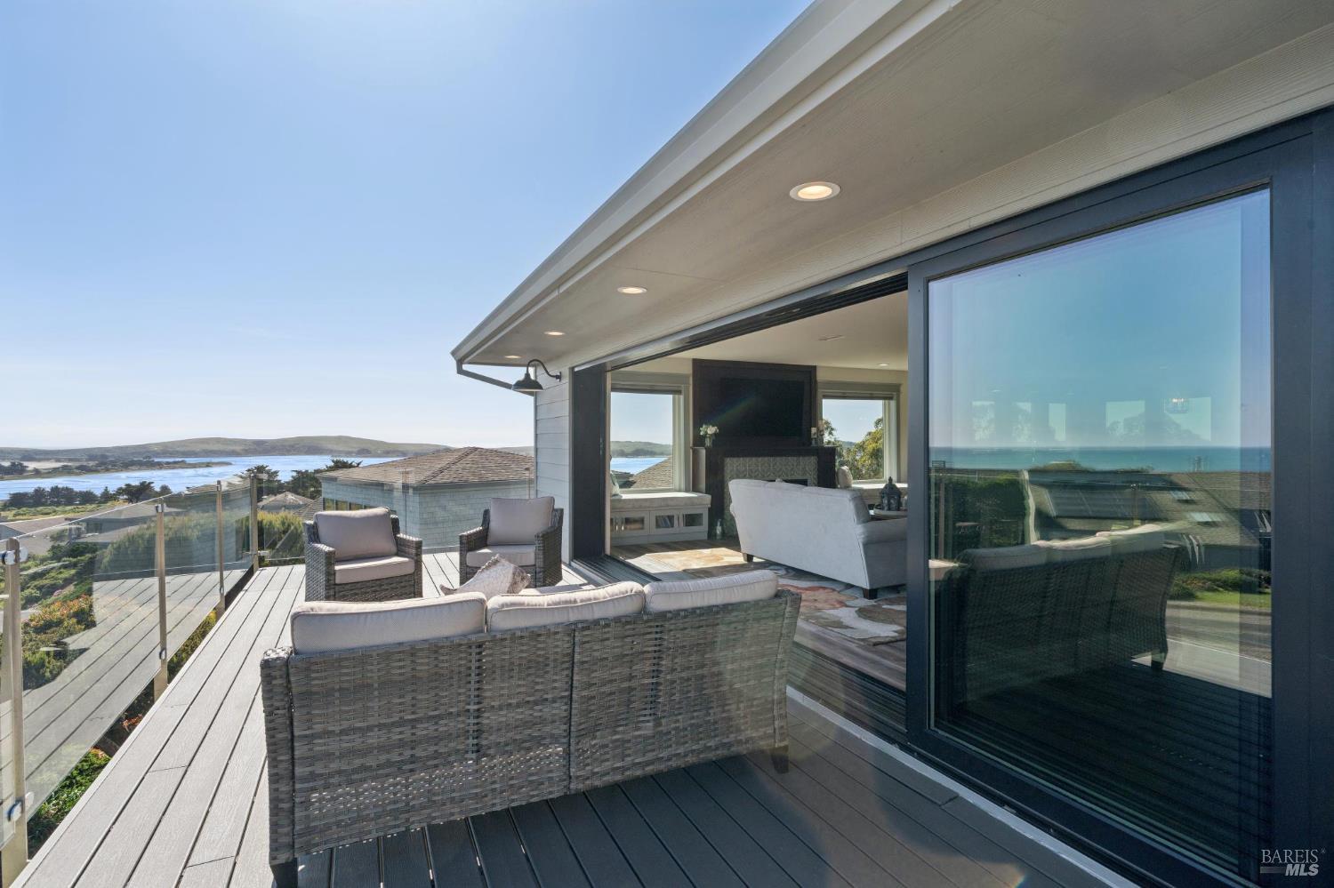 88 Cypress Loop Bodega Bay, CA 94923 - Photo 30 of 88 La Cantina glass doors open wide to provide seamless indoor outdoor flow to the deck off the open great room, kitchen, & dining area. Expansive views of Bodega Harbor, Bodega Bay, Bodega Head and the Pacific beyond gives you endless opportunity to entertain, relax, and enjoy breathtaking sunsets.
