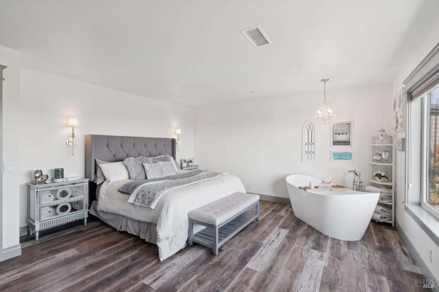 88 Cypress Loop Bodega Bay, CA 94923 - Photo 52 of 88 Primary suite featuring a spa-inspired soaking tub placed before an expansive window with ocean views, walk-in closet, and en suite bath.