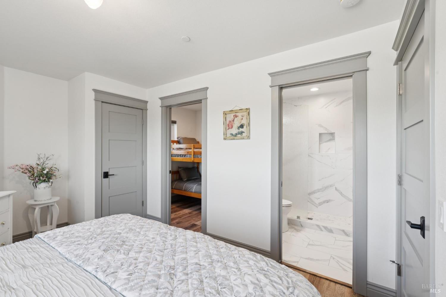 88 Cypress Loop Bodega Bay, CA 94923 - Photo 68 of 88 Lower level guest bedroom with a hillside view, walk-in closet (currently housing a bunk bed for extra sleeping space) and direct access to a full bathroom.