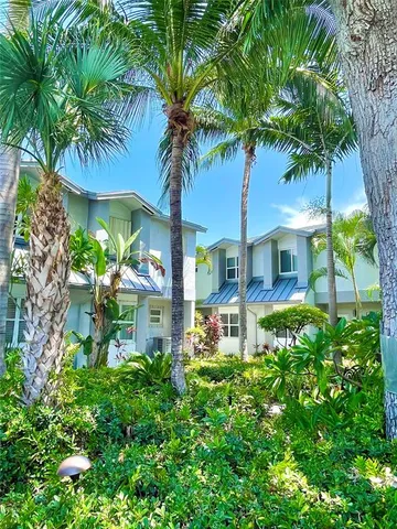 an aerial view of a house with a yard swimming pool and outdoor seating